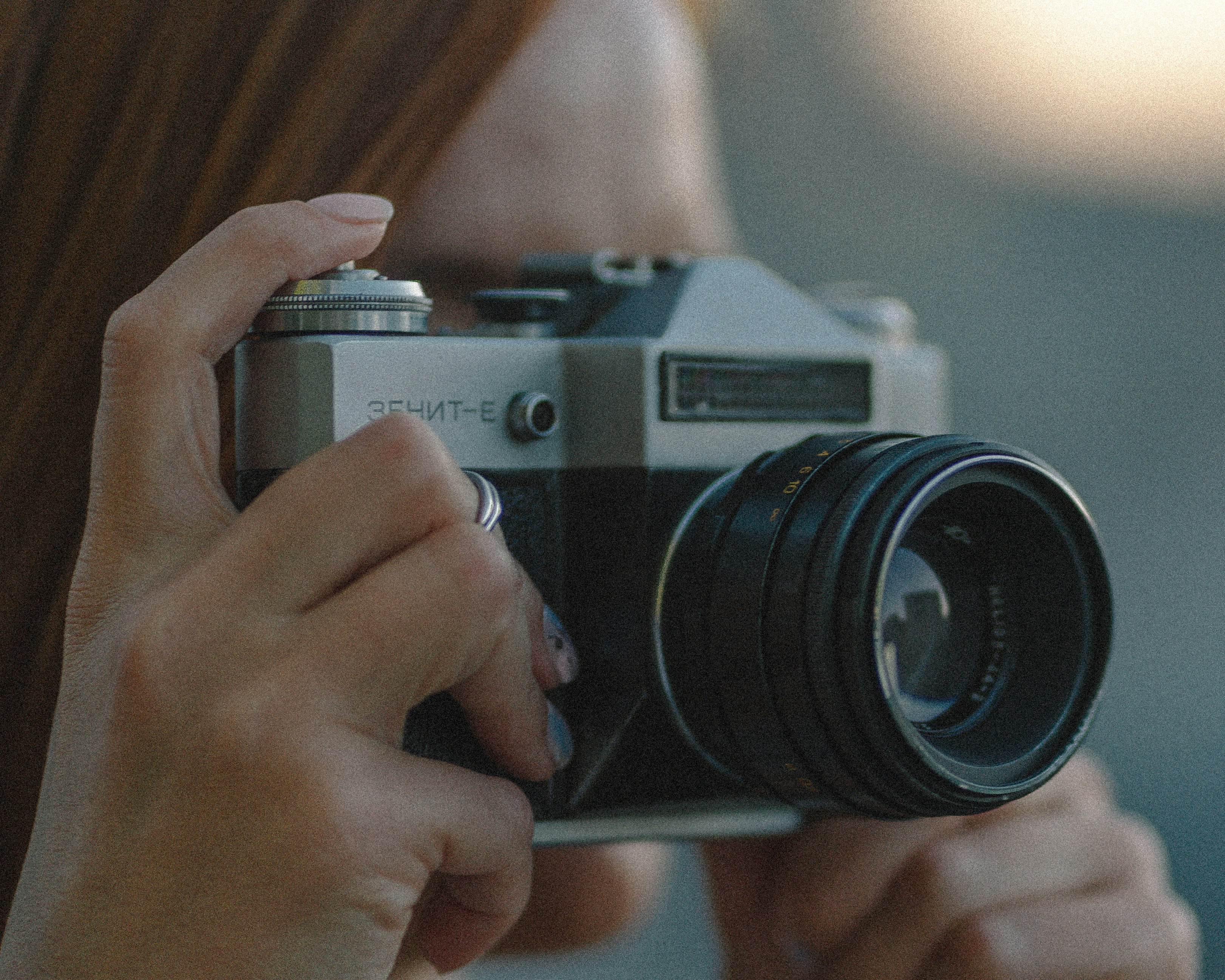 person holding gray and black camera